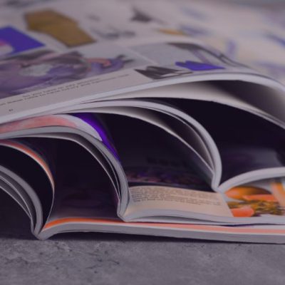 Zeitungen, die aufgeschlagen und gestapelt sind, stehen für Themenplanung.